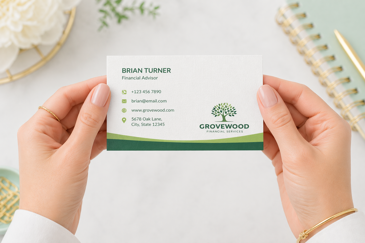 Person holding a business card with 'Grovewood' branding on a light background