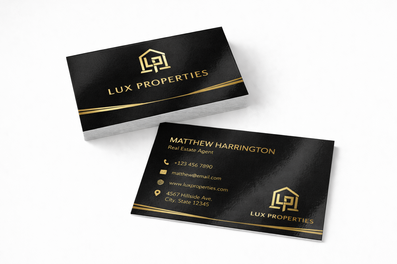 Lux Properties business cards with gold accents on a white background