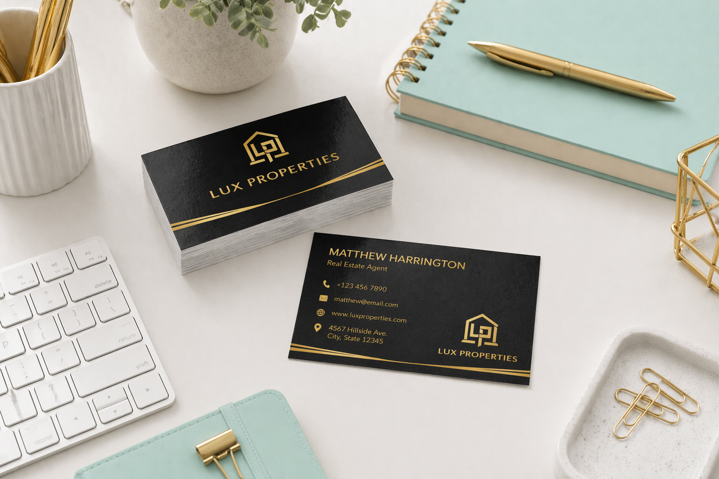 Lux Properties business cards on a desk with office supplies