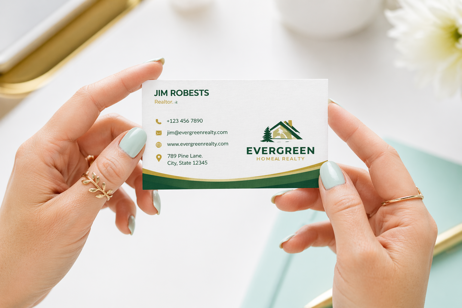 Person holding a business card with Evergreen Home Realty branding